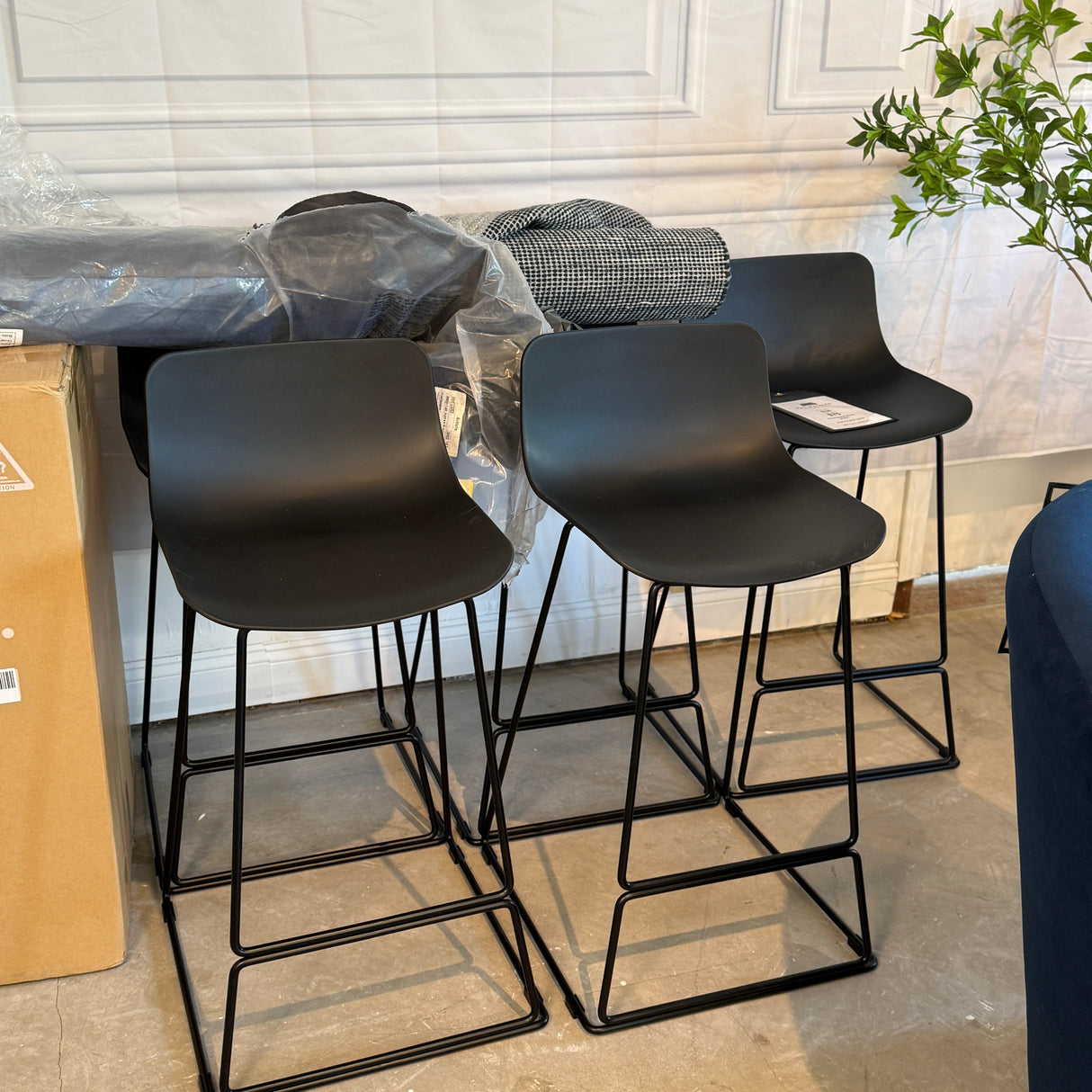 Black indoor/outdoor MCM counter height barstool by Article with sleek modern design and sturdy frame.