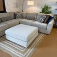 Behold Home Sequoia Accent Ottoman with wooden legs and plush fabric, shown as a stylish, versatile furniture piece in a modern living space.