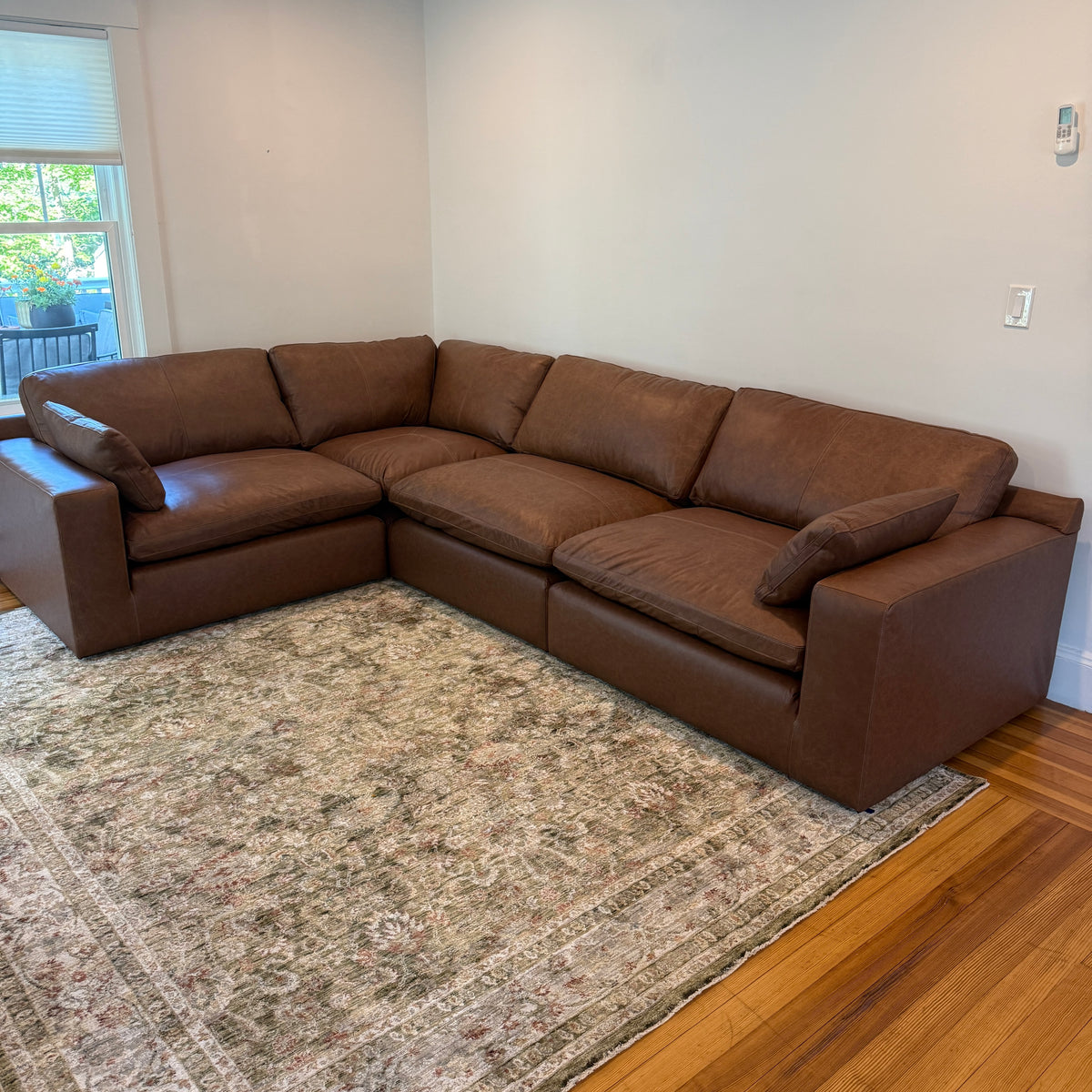 Ashley Furniture Atlas Reserve 4-piece corner sectional sofa with plush cushions and modern design, viewed from the front.