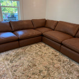 Ashley Furniture Atlas Reserve 5-piece sectional sofa with beige fabric, featuring corner and chaise sections.