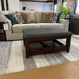 Roseville Ottoman coffee table by Pull Up A Couch, featuring a round design with a wooden finish and a sturdy base.