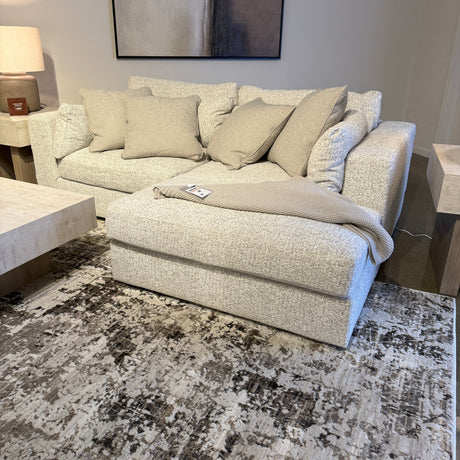 Ashley Furniture Alpine 2-piece sectional with chaise, featuring plush upholstery and modern design in a cozy living room setting.