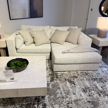Ashley Furniture Alpine 2-piece sectional with chaise, featuring plush upholstery and modern design in a cozy living room setting.