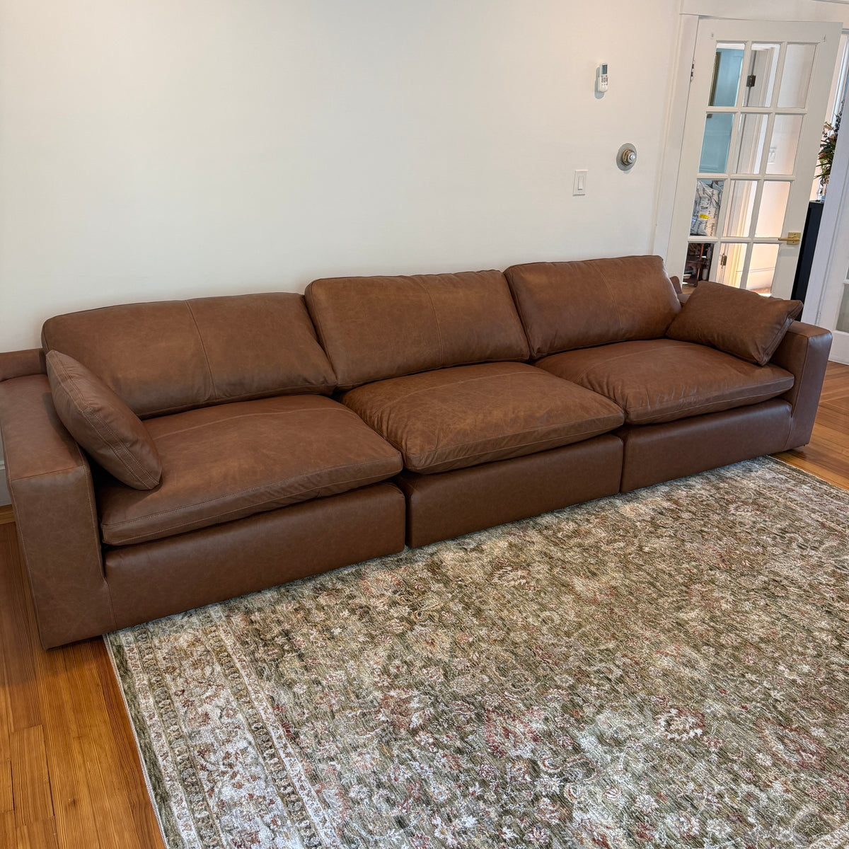 Ashley Furniture Atlas Reserve modular sofa set with three sections, showcasing plush cushions and modern design in a living room setting.