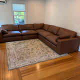 Ashley Furniture Atlas Reserve 5-piece sectional sofa with plush cushions and modern design, shown in a cozy living room setting.