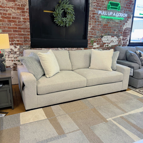 Comfortable Ashley Furniture Hudson sofa with plush cushions and neutral fabric, ideal for living room seating.