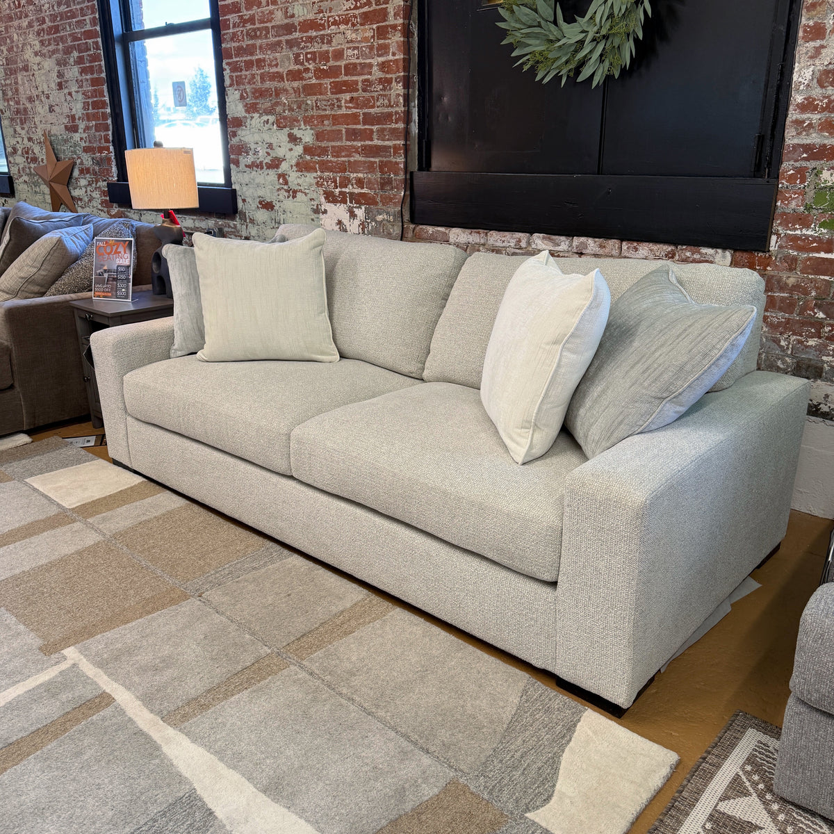 Ashley Furniture Hudson Sofa with plush cushions and contemporary design, shown in a stylish living room setting.