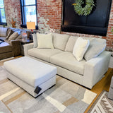 Ashley Furniture Hudson Sofa with plush fabric and tufted cushions, showcasing a modern design in a living room setting.