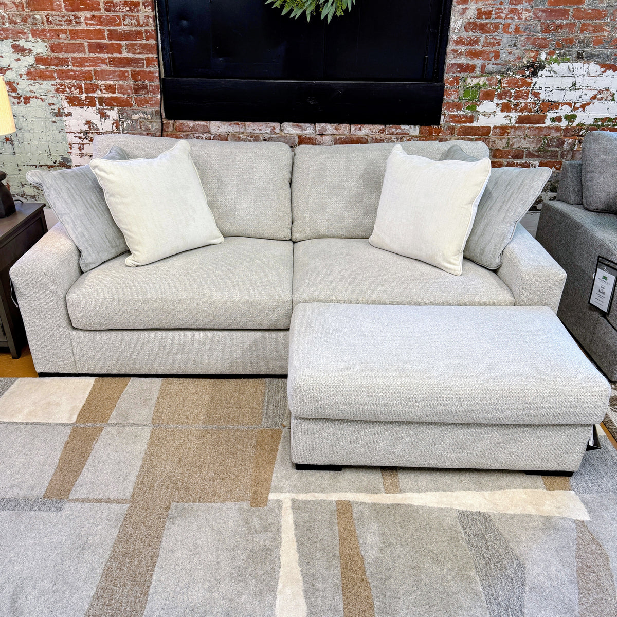 Ashley Furniture Hudson Sofa, plush fabric sofa with modern design and neutral color, shown in a well-lit living room setting.