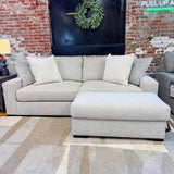 Ashley Furniture Hudson Sofa, plush fabric upholstery with tufted back and rolled arms, shown in a stylish living room setting.