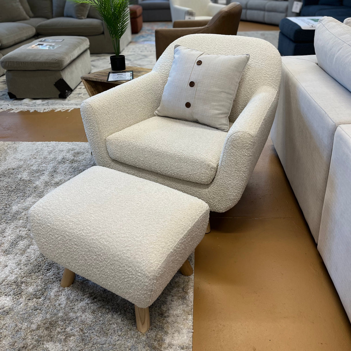 Ivory bouclé lounge chair with matching ottoman by Article, featuring plush fabric and modern design for stylish comfort.