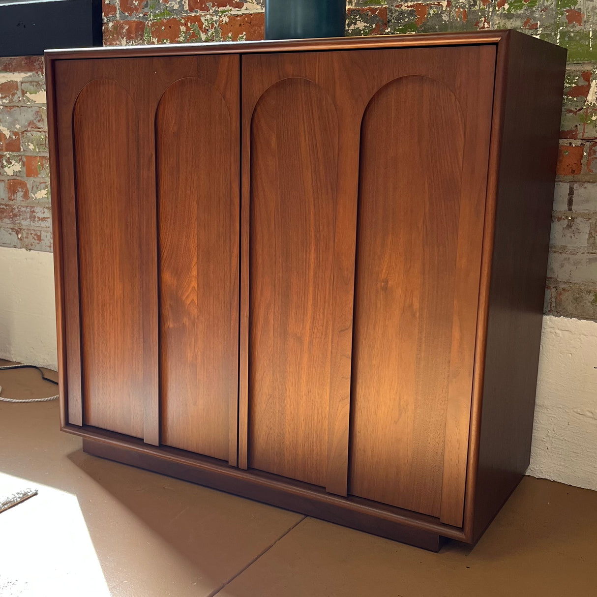 Elegant 37-inch walnut Article MCM cabinet with open storage shelves and sleek modern design, perfect for stylish home organization.