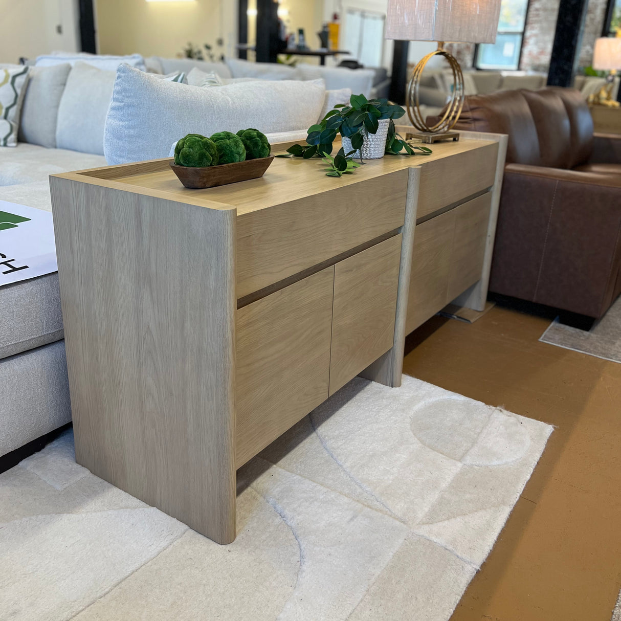 White oak 70-inch MCM-style sideboard by Article with sleek modern design and minimalist handles.