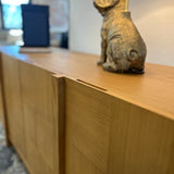 Natural oak MCM-style sideboard measuring 66 inches, sleek design with clean lines, modern storage solution from Article.