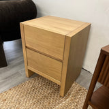 White oak 2-drawer MCM nightstand by Article with sleek design and modern handles, ideal for bedroom storage.