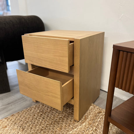 White oak 2-drawer MCM nightstand by Article with sleek modern design and clean lines, showcasing a minimalist bedroom accent piece.