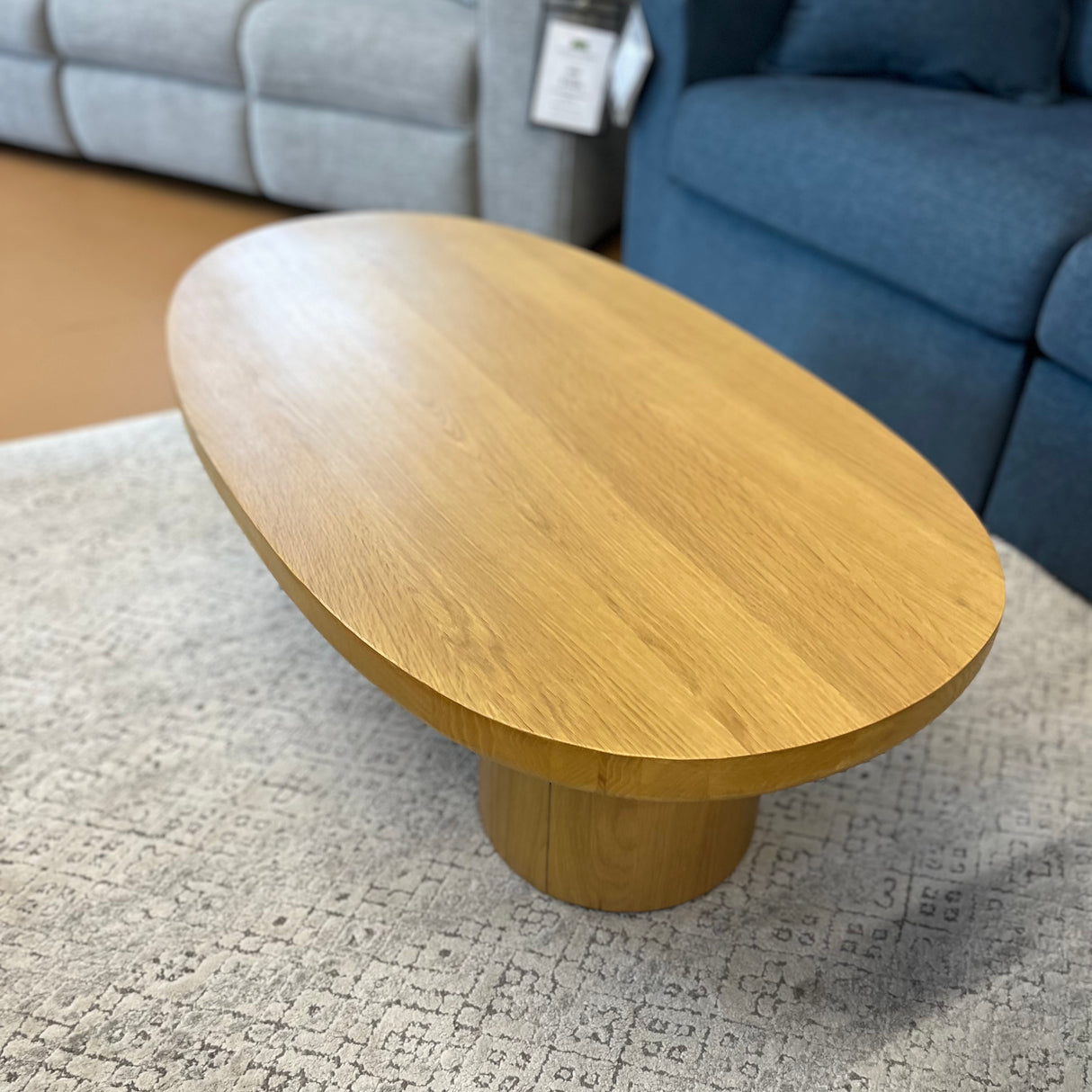 Oak 46-inch MCM-style coffee table by Article featuring a sleek, modern design with a smooth finish and sturdy wooden legs.