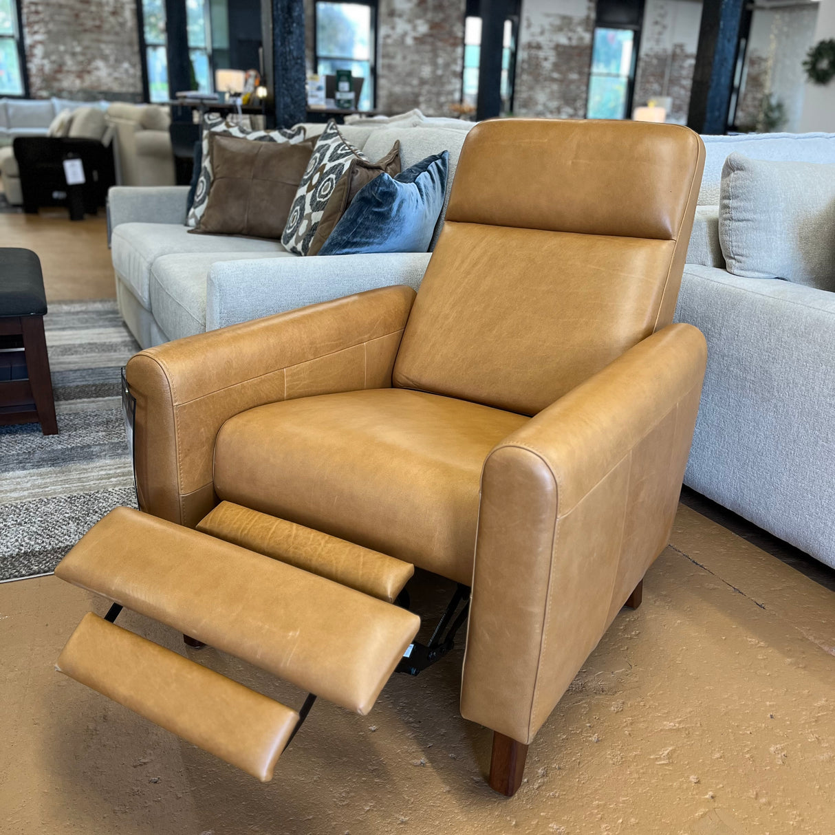 MCM recliner chair in Taos tan leather with plush cushioning and wooden legs, modern design from Article.