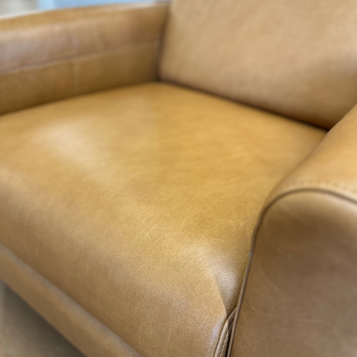 Article MCM recliner chair in Taos tan leather, showcasing a plush, comfortable seating with a modern design.