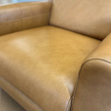 Article MCM recliner chair in Taos tan leather, showcasing a plush, comfortable seating with a modern design.