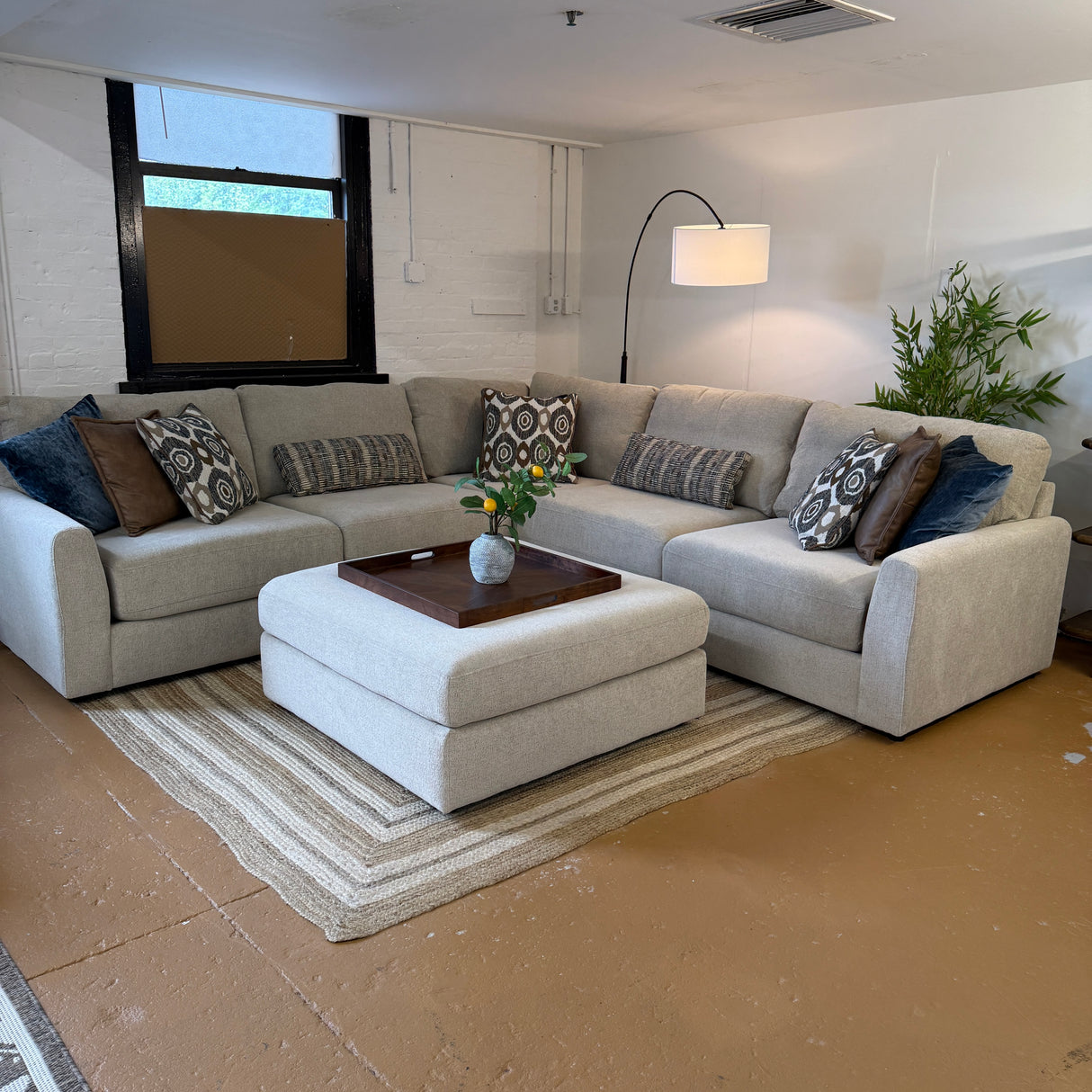 Behold Home Sequoia Accent Ottoman with wooden legs and plush fabric upholstery, ideal for living room decor.