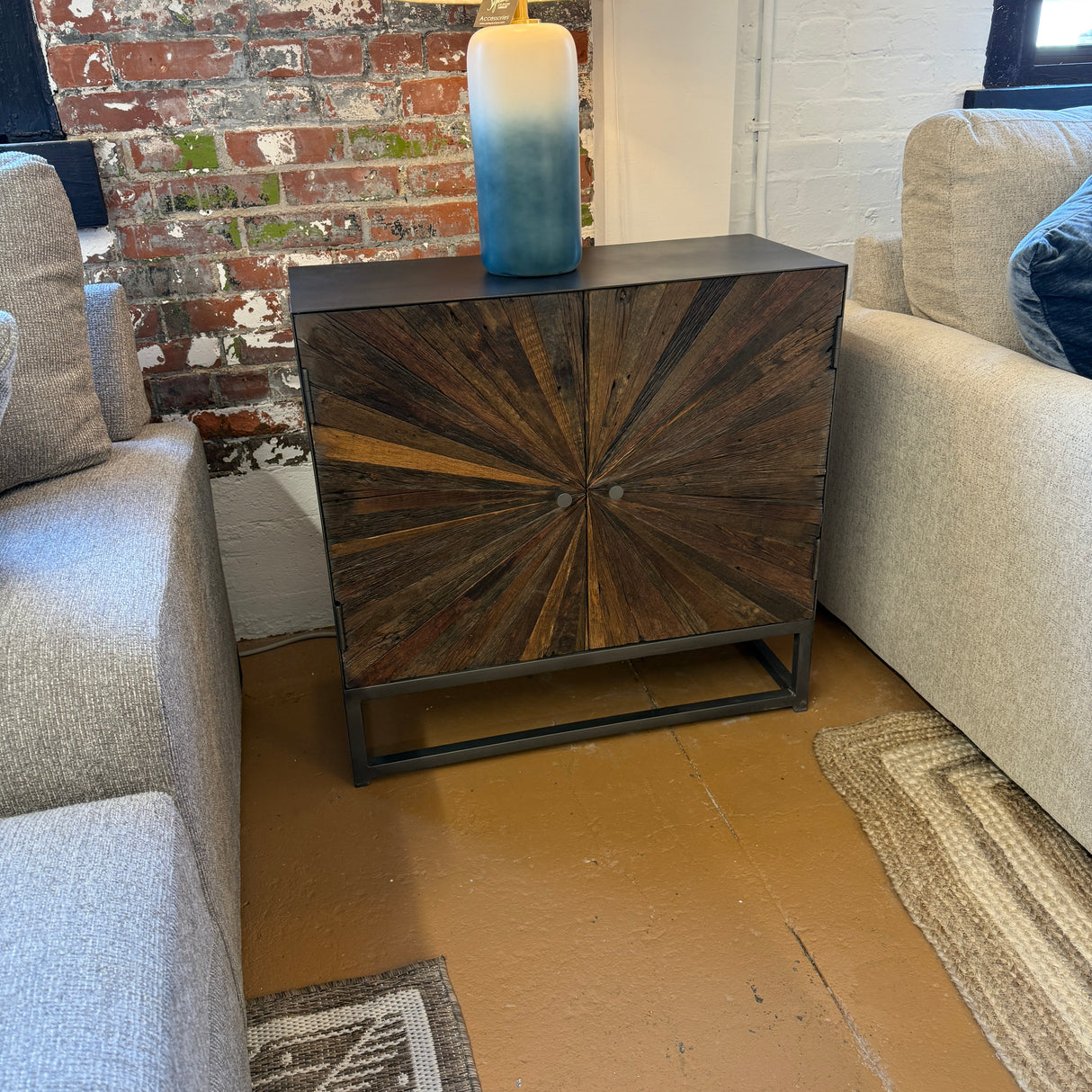 Pull Up A Couch Cedarville Accent Cabinet with wooden doors and modern design, standing on a light-colored floor.