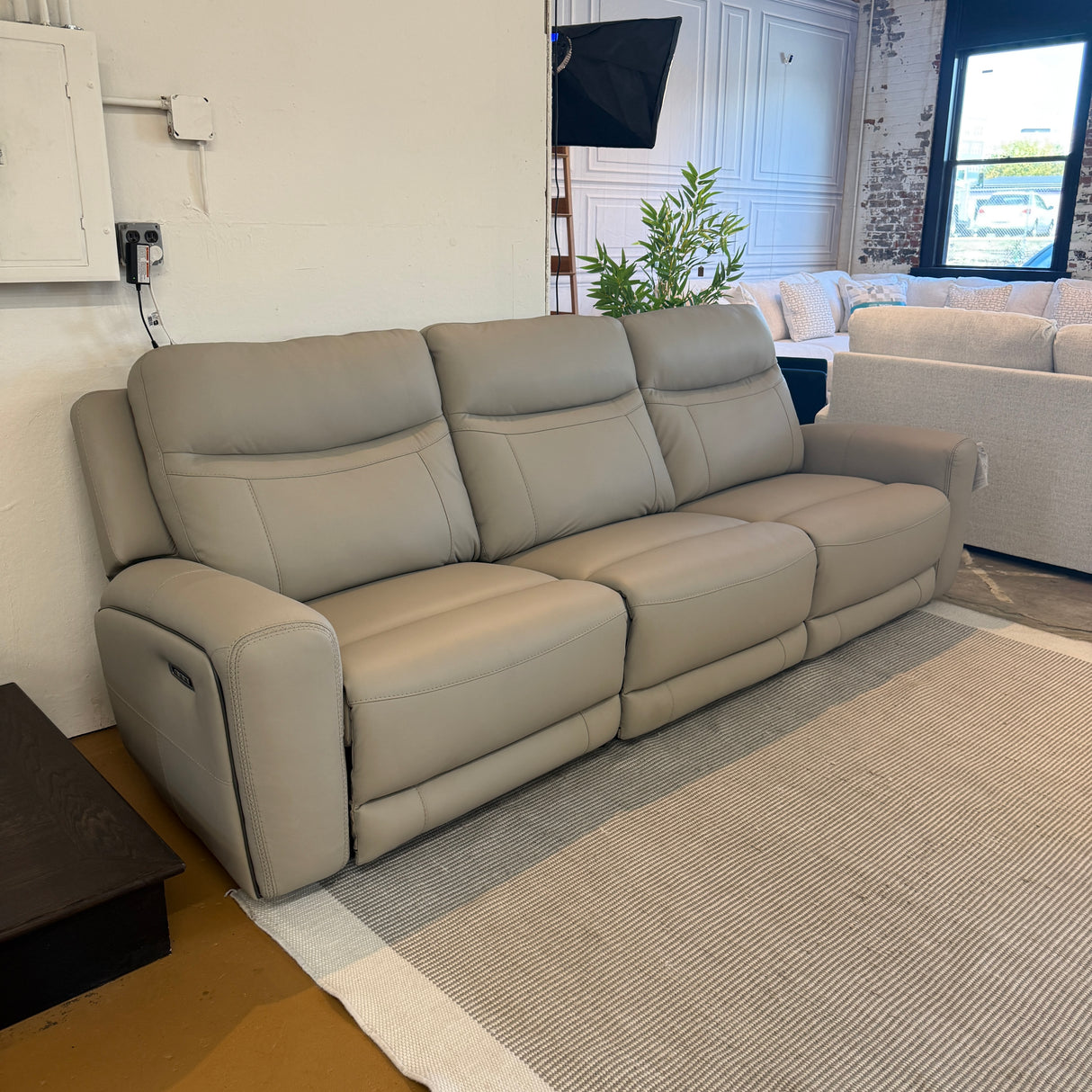 Ashley Furniture Salerno power reclining sofa, a three-piece sectional in neutral fabric with plush cushions and reclining features.