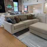 Behold Home Sequoia Accent Ottoman with wooden legs and fabric upholstery, showcasing a stylish and versatile small seating piece.