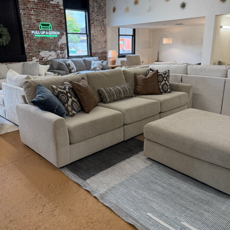 Behold Home Sequoia Accent Ottoman with wooden legs and fabric upholstery, showcasing a stylish and versatile small seating piece.