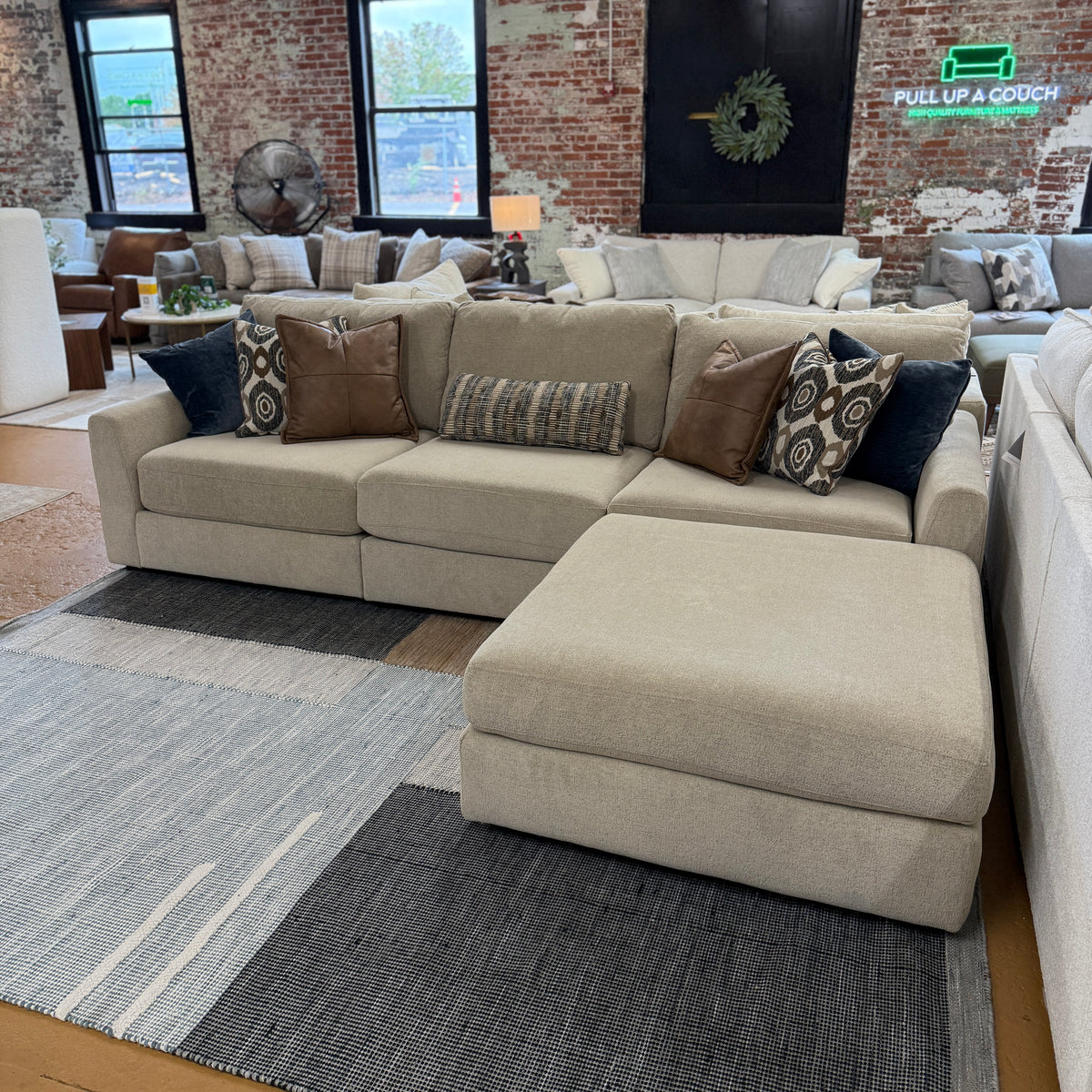 Behold Home Sequoia Accent Ottoman with wooden legs, upholstered in soft fabric, placed in a modern living room setting.