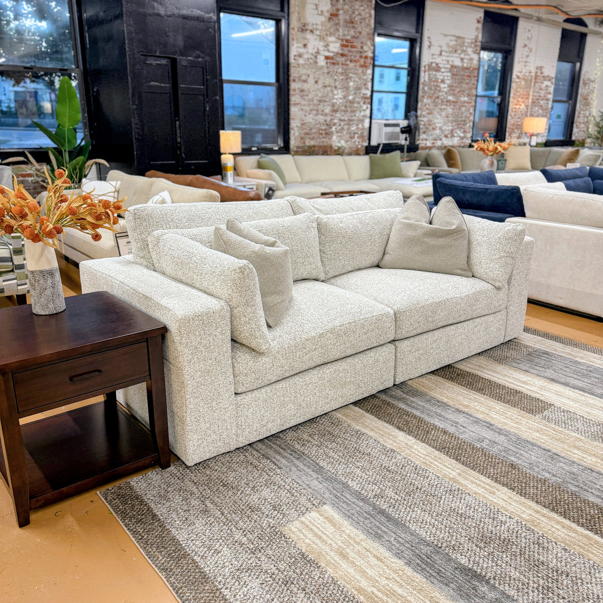 Ashley Furniture Alpine 2-piece sectional sofa with plush cushions and modern design, shown in a cozy living room setting.