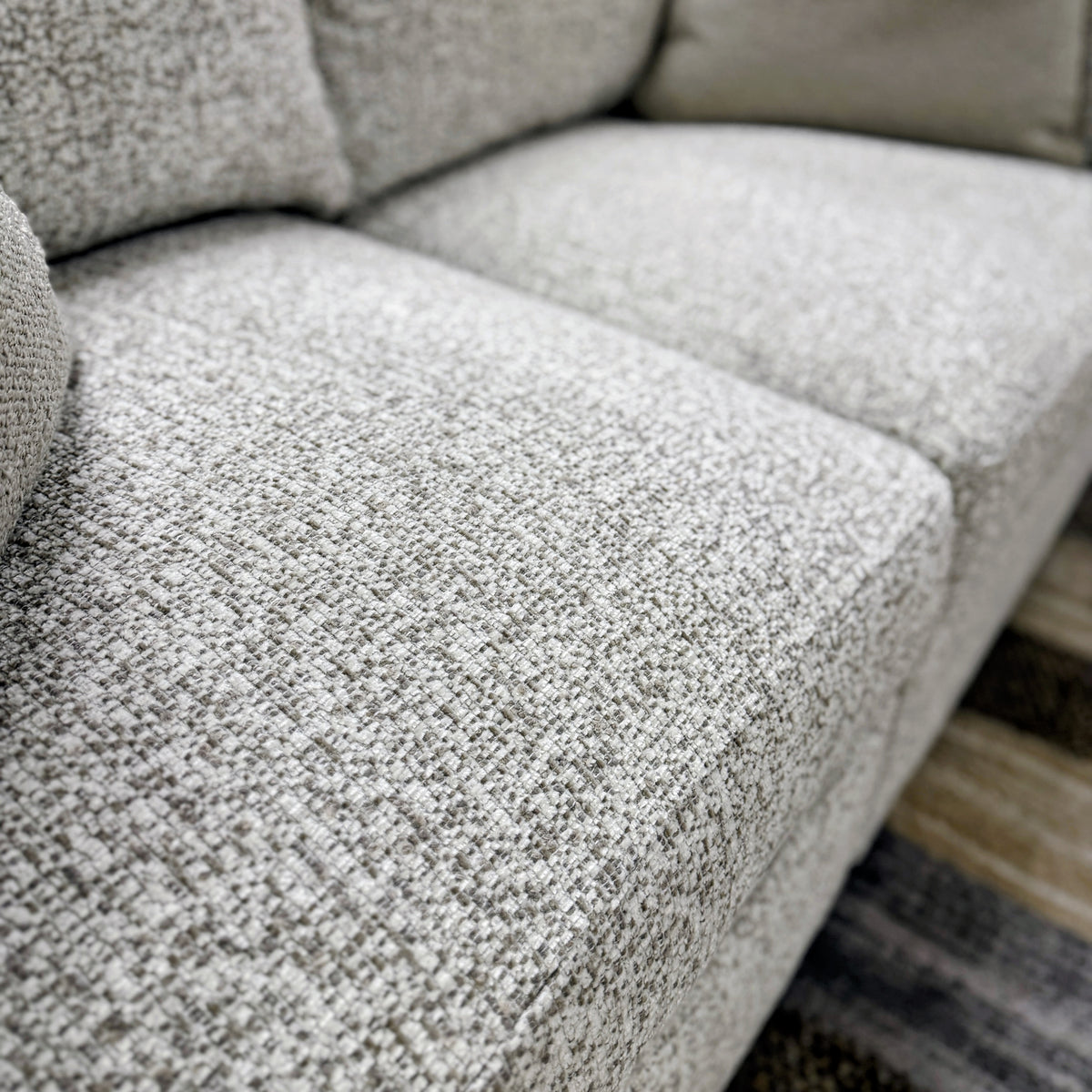 Large oversized Ottoman from Ashley Furniture featuring plush upholstery and a neutral fabric, perfect for living room decor.