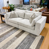 Alpine 2-piece sectional sofa by Ashley Furniture with plush cushions and modern design, shown in a cozy living room setting.