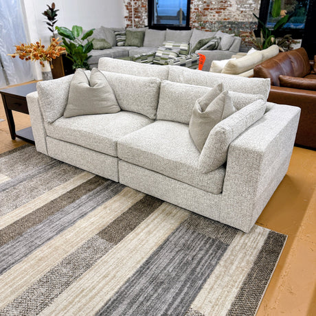 Alpine 2-piece sectional sofa by Ashley Furniture with plush cushions and modern design, shown in a cozy living room setting.