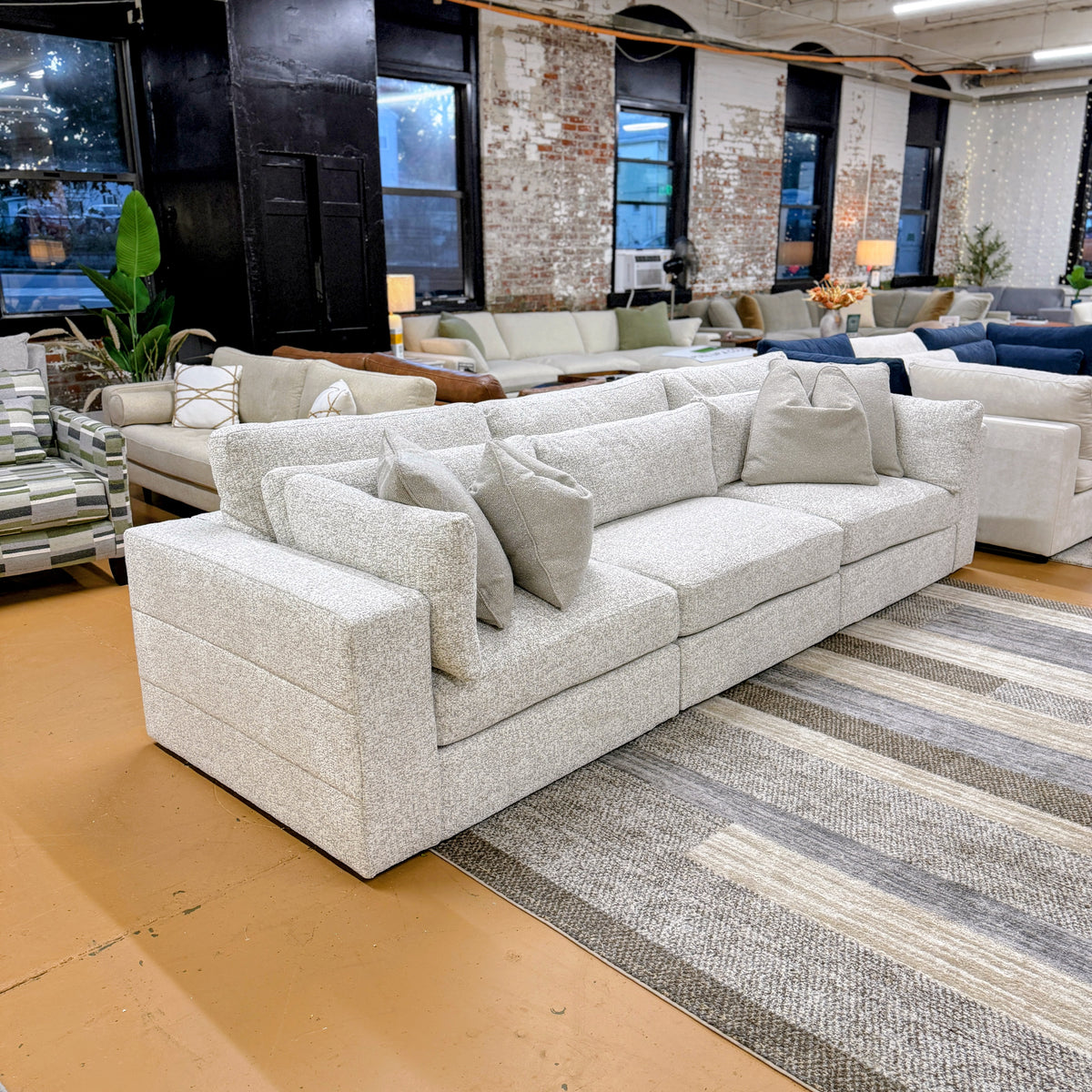 Ashley Furniture Alpine 3-piece sectional sofa with plush cushions and modern design, shown in a cozy living room setting.
