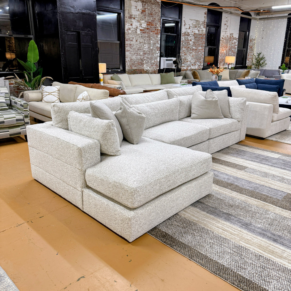 Ashley Furniture Alpine 3-piece sectional with chaise, featuring plush cushions and a modern design for comfortable living space.