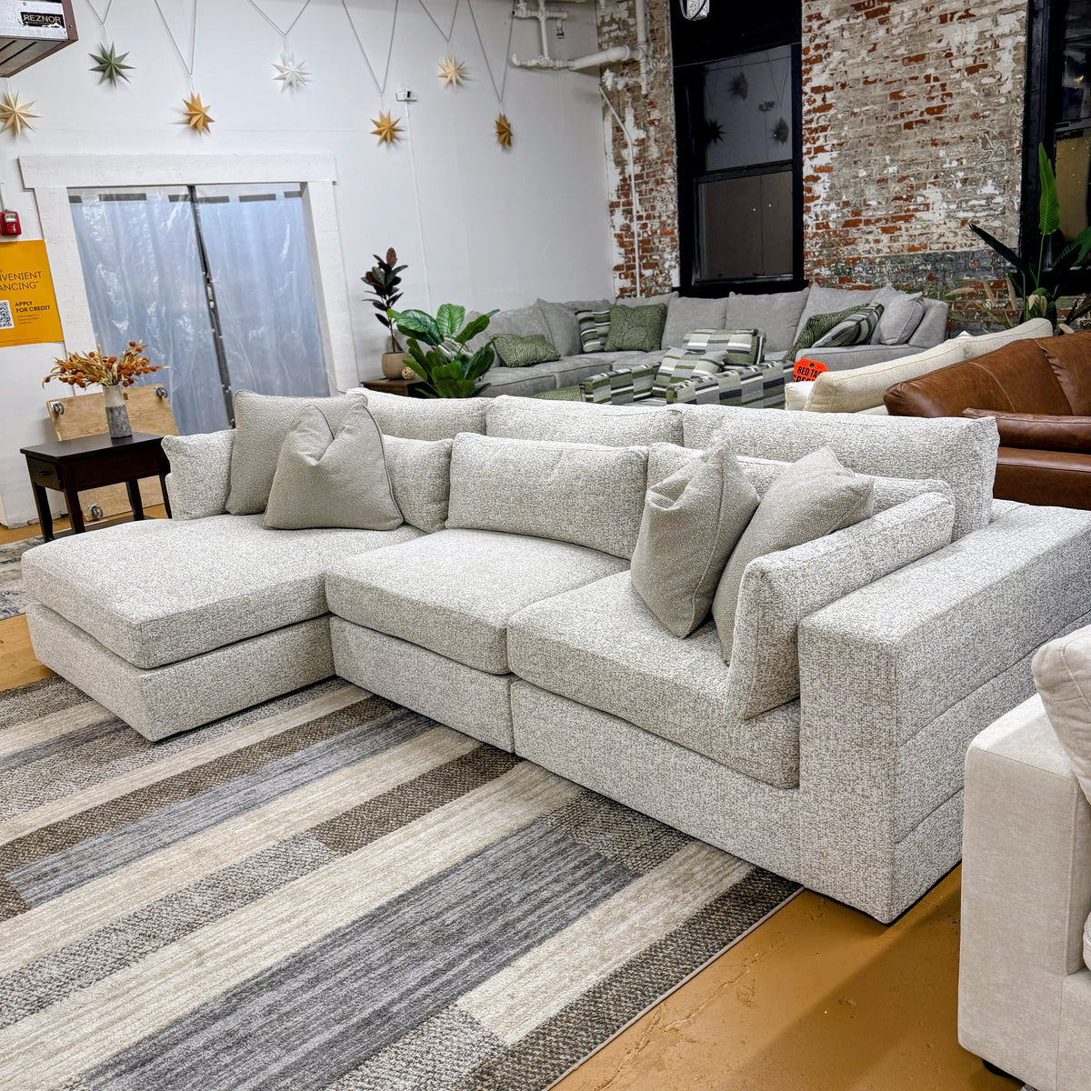 Ashley Furniture Alpine 3-piece sectional with chaise, soft fabric upholstery, and modern design, perfect for living room seating.