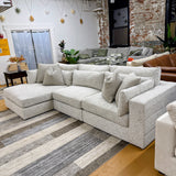 Ashley Furniture Alpine 3-piece sectional with chaise, soft fabric upholstery, and modern design, perfect for living room seating.
