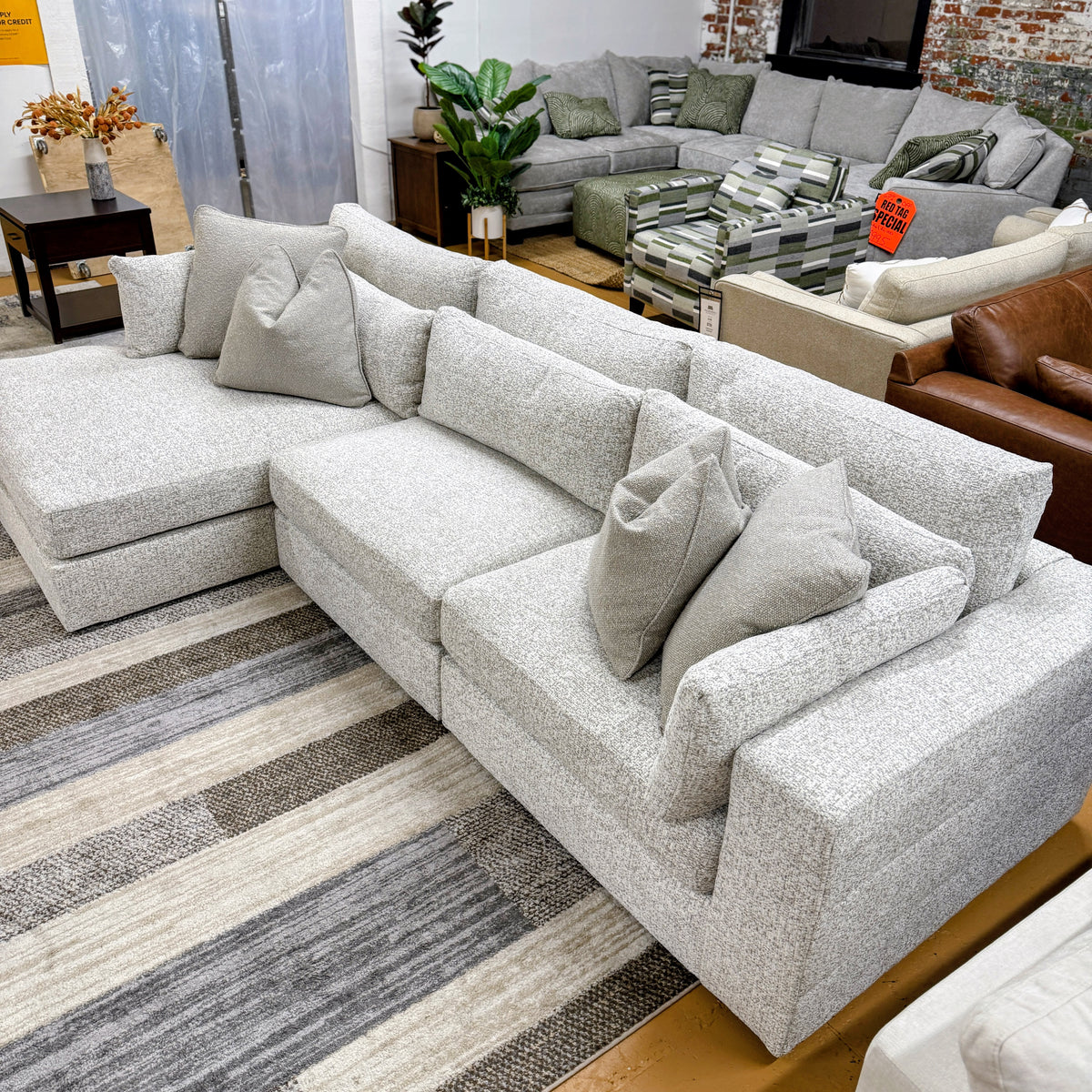 Ashley Furniture Alpine 3-piece sectional with chaise, showing plush fabric upholstery and modern design in a stylish living room setting.