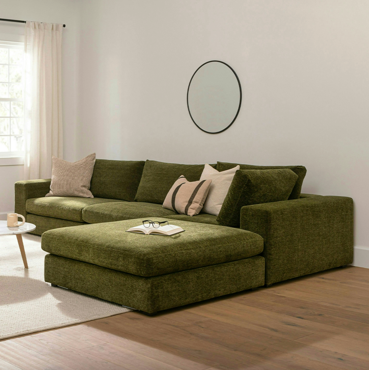 Cypress green 4-piece modular sectional sofa with ottoman by Article, showing the spacious, modern fabric seating arrangement.