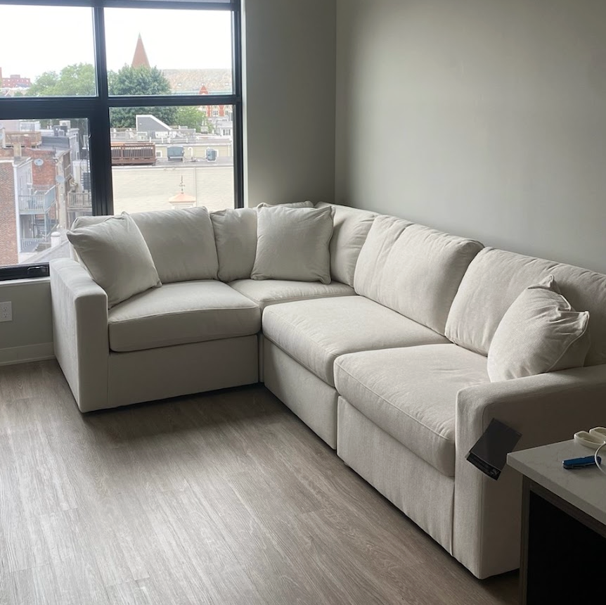 Ashley Furniture Modmax Corner Sectional, 4-piece sofa set with plush cushions and modern design, shown in a stylish living room.