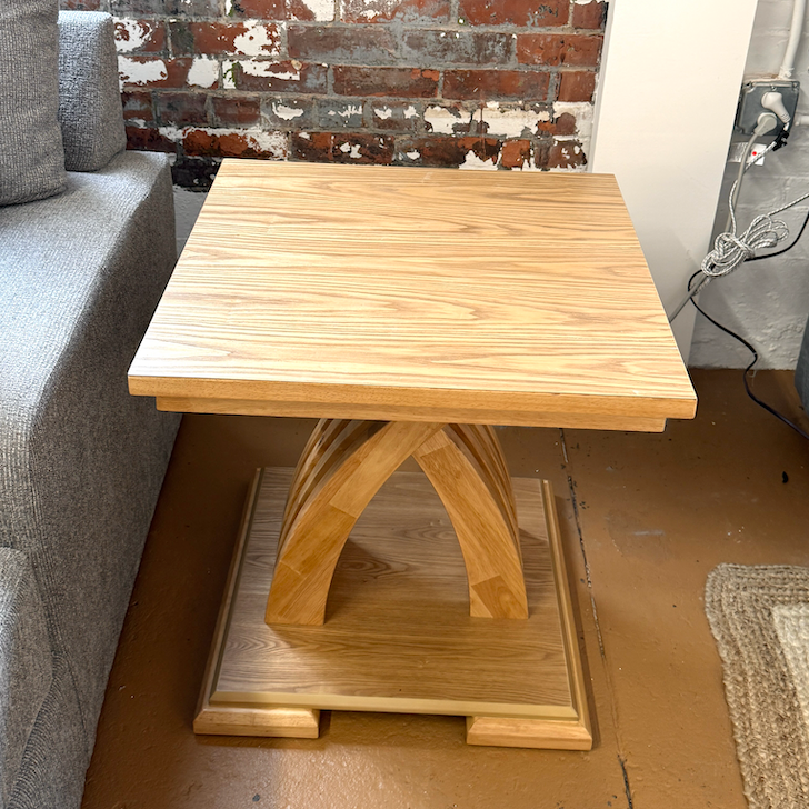 Pull Up A Couch Lamia end table featuring a sleek design with a wooden top and metal legs for modern living room decor.