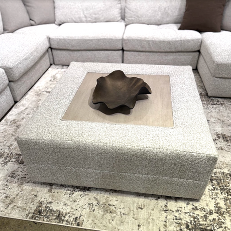 Large oversized ottoman by Ashley Furniture, featuring plush fabric and a spacious design for versatile living room seating.
