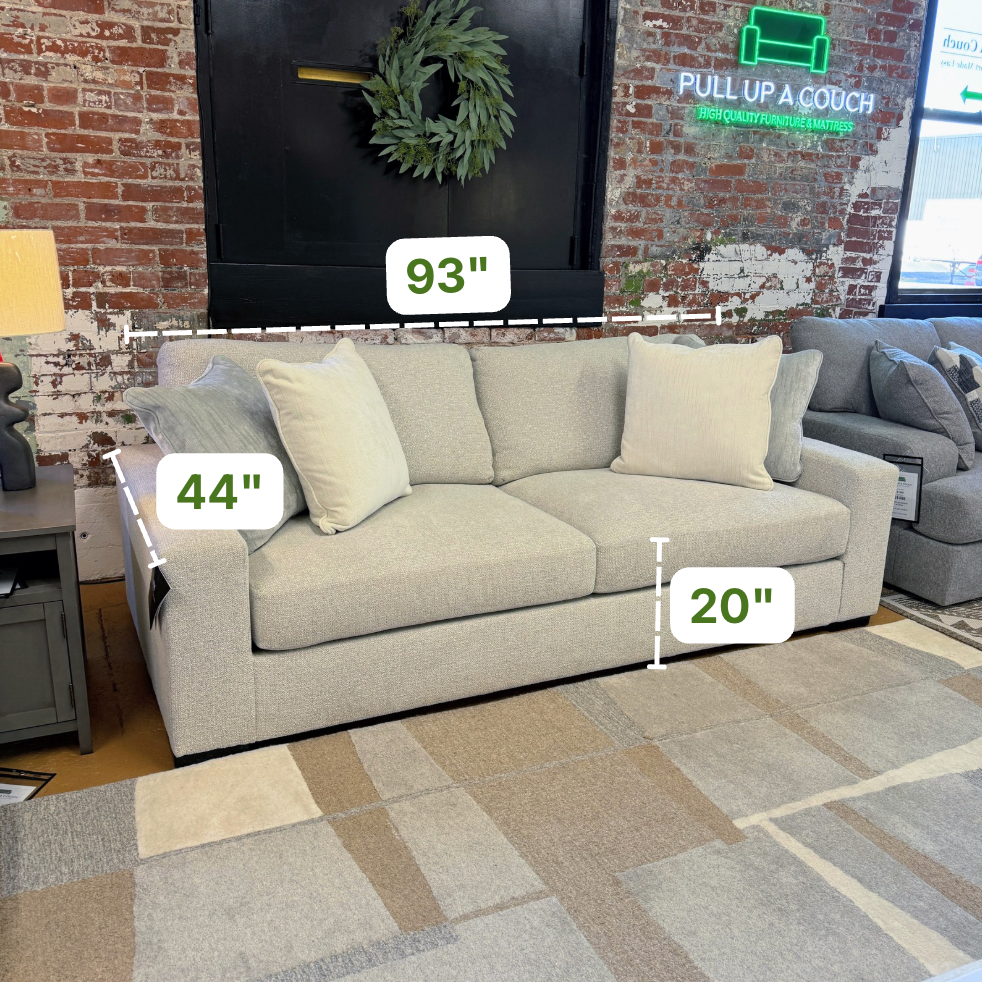 Ashley Furniture Hudson Sofa, plush upholstered sofa with rolled arms and wooden legs, ideal for living room comfort.