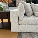 Ashley Furniture Alpine 2-piece sectional sofa arm with beige upholstery and plush cushioning, showing detailed fabric texture.
