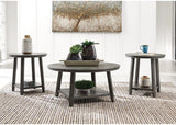 Set of three Ashley Furniture Caitbrook tables, featuring wooden tops and tapered legs, arranged together in a modern living room setting.