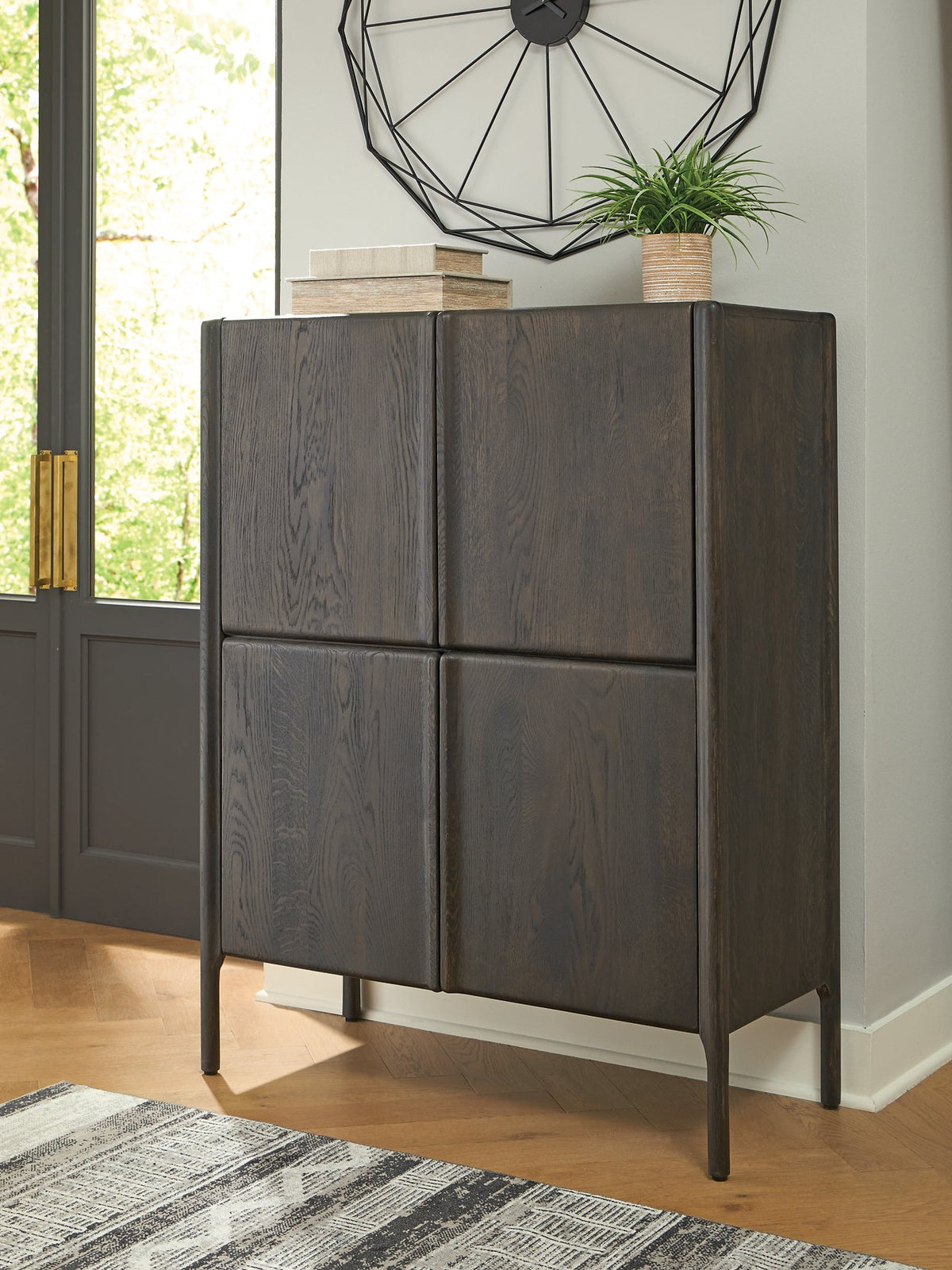 Ashley Furniture Orsonal Accent Cabinet with sleek wood finish and modern design, featuring multiple storage compartments.