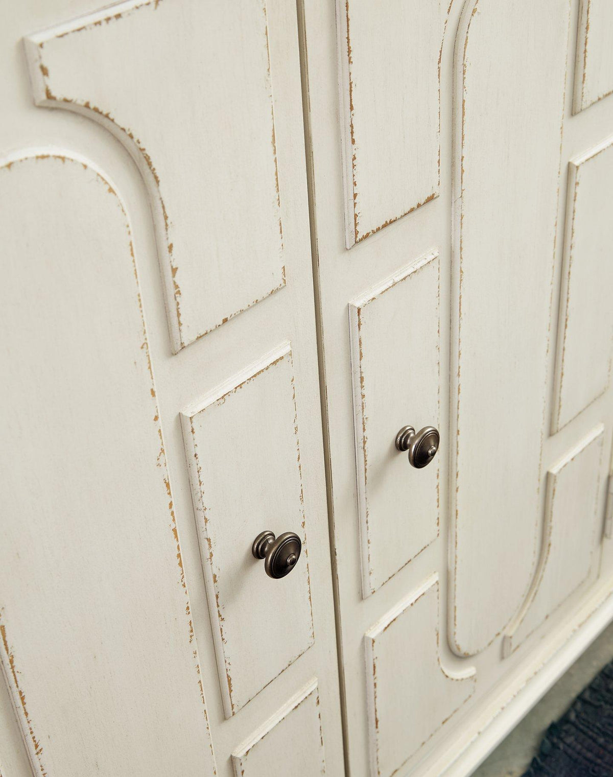 Ashley Roranville accent cabinet with wooden finish, featuring storage drawers and decorative details for living room or hallway.