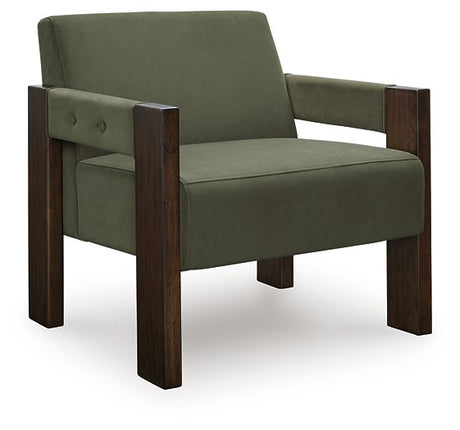 Ashley Furniture Adlanlock accent chair with plush fabric and wooden legs, shown from a side angle with modern design details.