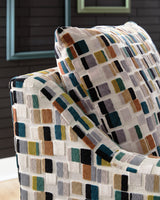 Ashley Furniture Fenna Accent Chair with plush fabric and wooden legs, shown in a stylish living room setting.